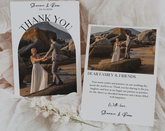 May include: A wedding thank you card featuring a photograph of the couple on a beach with rocks. The card has a black and white design with the text "Thank You" and "Shannon & Ross" in a contemporary font.