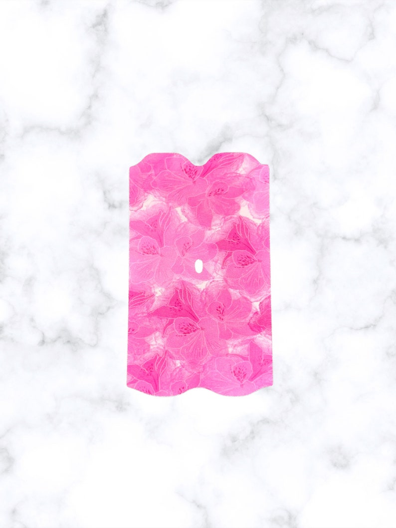 May include: Pink floral patterned fabric with a wavy edge. The fabric has a white background with pink flowers.