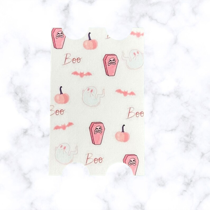 May include: Pink and white patterned paper with a repeating design of coffins, ghosts, bats, pumpkins, and the word "Boo".