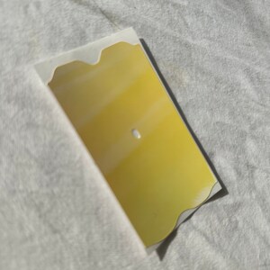May include: A yellow, wavy-edged, rectangular sign with a white center.