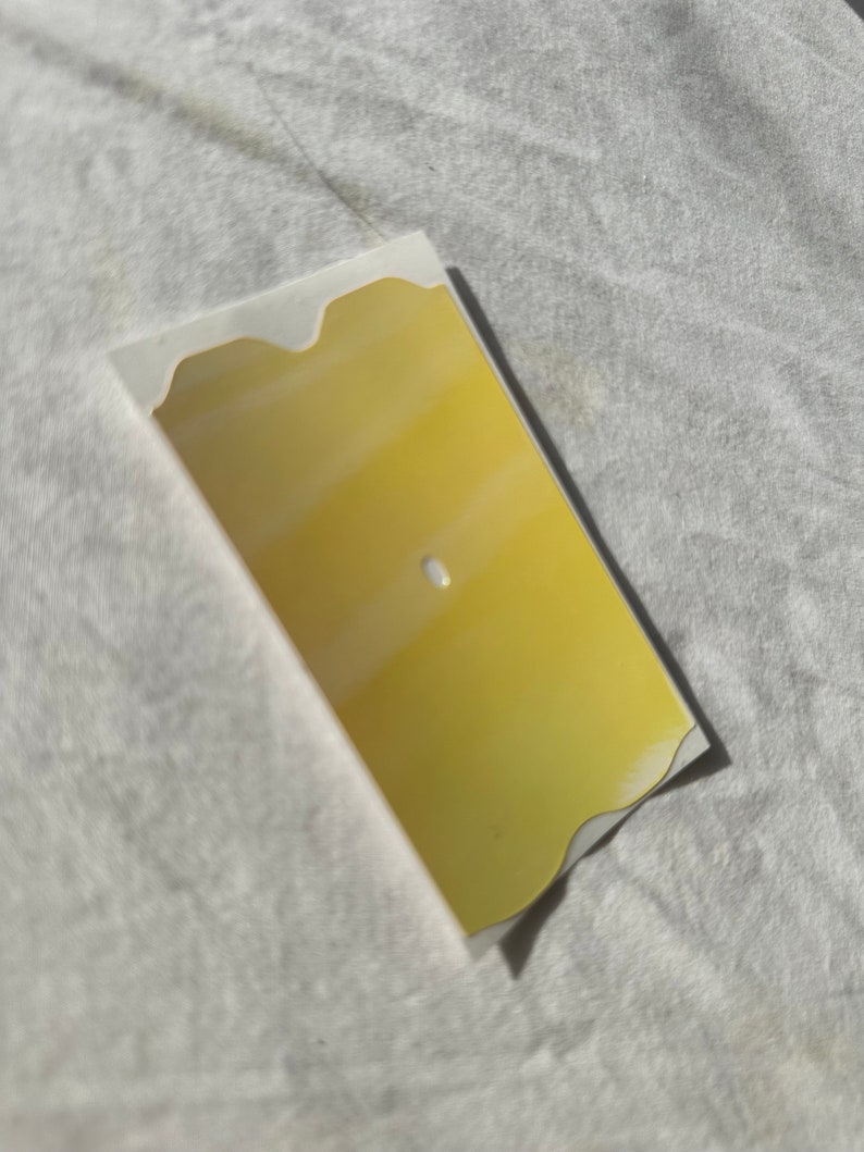 May include: A yellow, wavy-edged, rectangular sign with a white center.