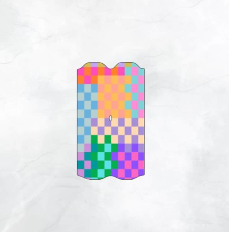 May include: A colorful, patterned phone case with a checkerboard design. The case features a vibrant mix of colors including pink, orange, blue, green, and purple. The case has a unique, curved top edge and a small hole near the center.