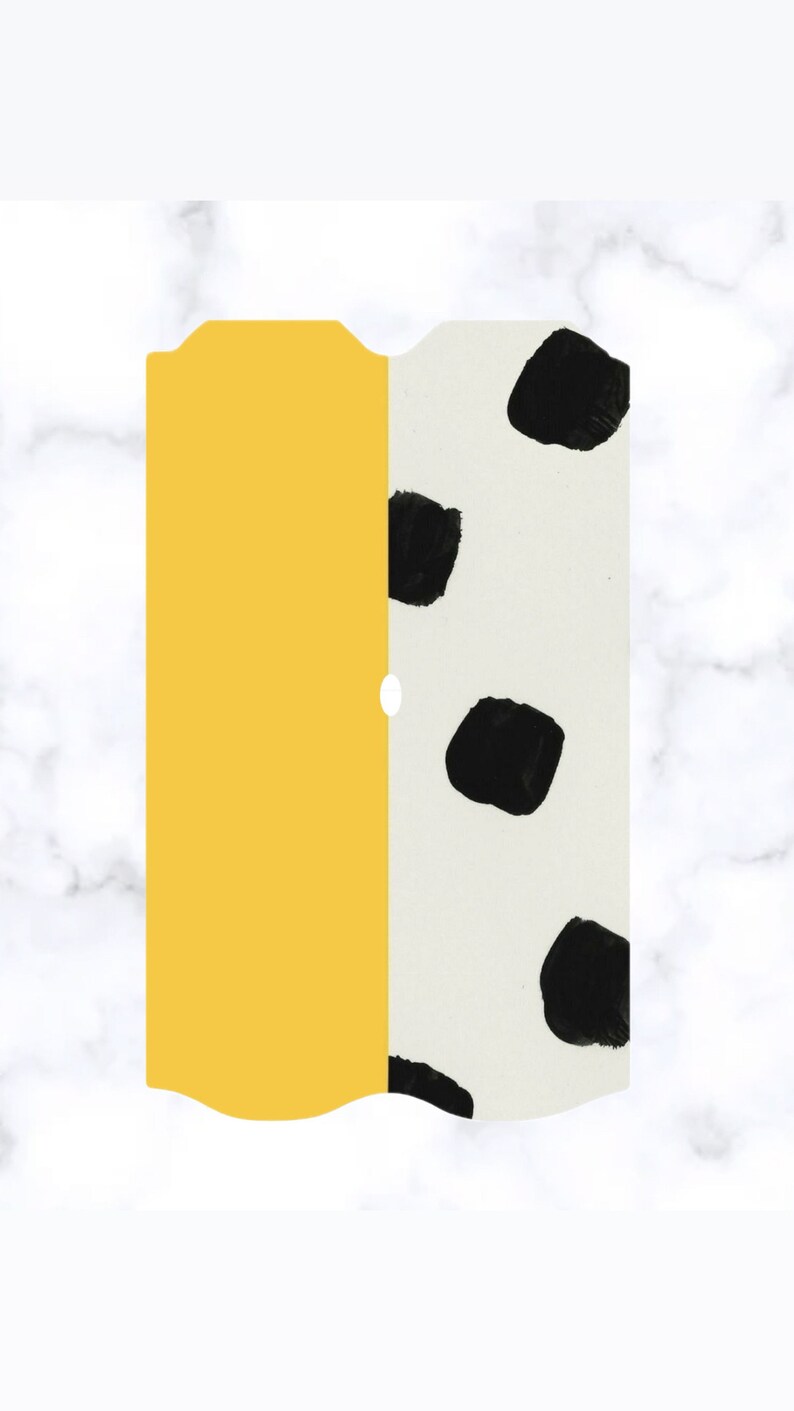 May include: A yellow and white sticker with black polka dots. The sticker has a wavy edge and a hole in the center.
