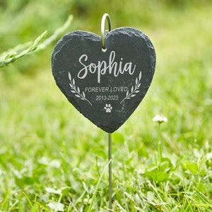 May include: Black heart-shaped slate garden marker with the name "Sophia" engraved, along with the text "Forever Loved 2013-2023" and a paw print.