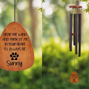 May include: Wooden wind chime with a brown finish, featuring a paw print and the name "Sunny". The chime includes the text "Hear the wind and think of me in your heart I'll always be." The wind chime has black tubes and a wooden top.