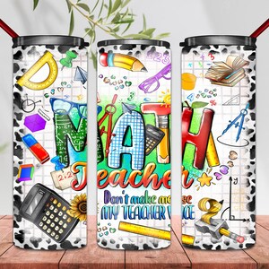 May include: Three stainless steel tumblers with a cow print design. The tumblers feature a colorful graphic of math-related items, including a calculator, protractor, pencil, and the word "MATH Teacher". The middle tumbler has the text "Don't make me use my teacher voice".