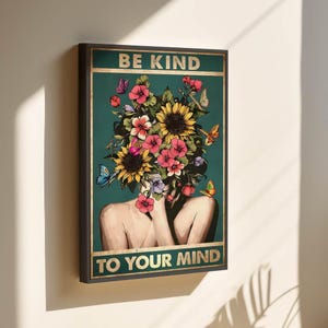 May include: Framed art print showing a woman with a floral headpiece of sunflowers, pink flowers, and butterflies. The text "BE KIND TO YOUR MIND" is in gold lettering on a teal background.