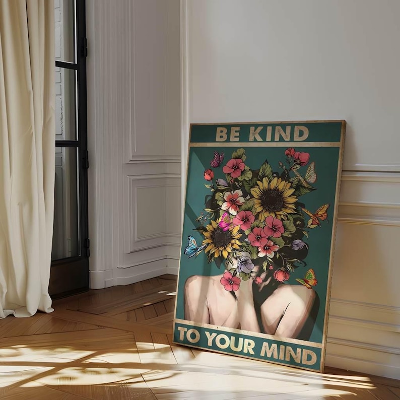 May include: A framed poster with the text "BE KIND TO YOUR MIND." The artwork depicts a woman's torso and head, with a floral arrangement replacing the head. The flowers are a mix of pink, yellow, and orange, with butterflies scattered throughout.