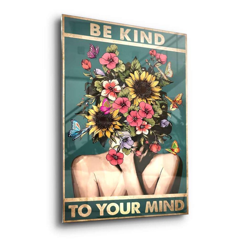 May include: A wall art print with a woman depicted with a floral headpiece and butterflies. The artwork features the text "BE KIND TO YOUR MIND" in gold lettering. The floral arrangement includes sunflowers, pink and red flowers, and green leaves.