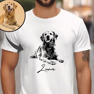 May include: White t-shirt featuring a black and white illustration of a golden retriever dog lying down. The dog's name, "Luna", is written in cursive below the illustration.