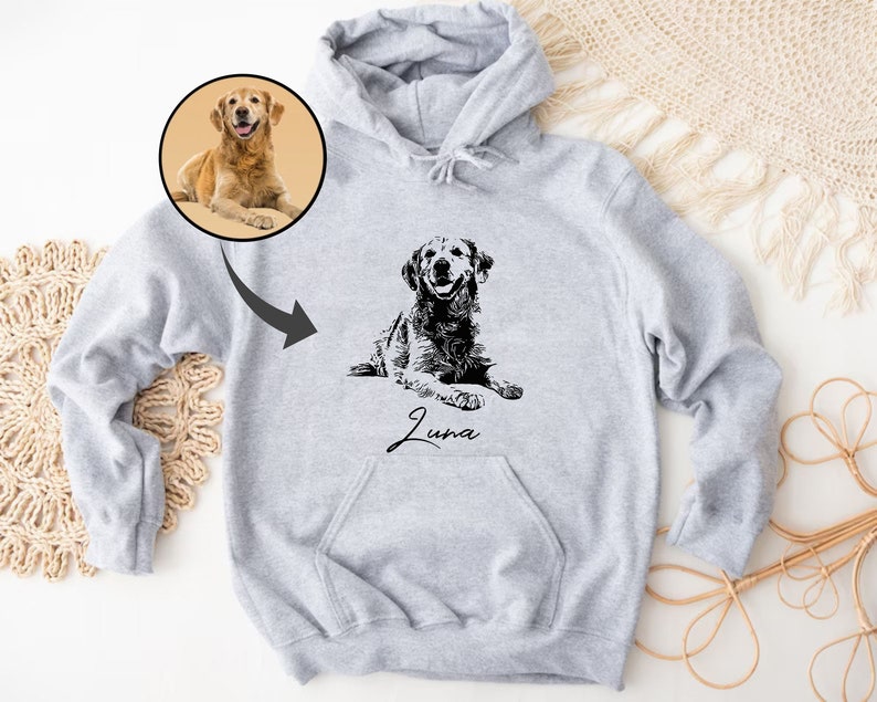 May include: A gray hoodie with a black and white illustration of a dog on the front. The dog is a Golden Retriever and the name "Luna" is written below the image.