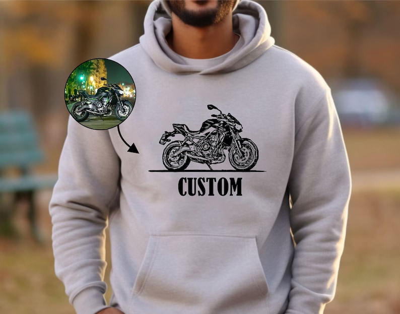 May include: A gray hooded sweatshirt with a black and white illustration of a motorcycle and the word "CUSTOM" printed on the front.