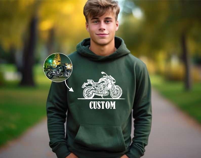 May include: A dark green hooded sweatshirt with a white outline of a motorcycle and the word "CUSTOM" printed on the front.