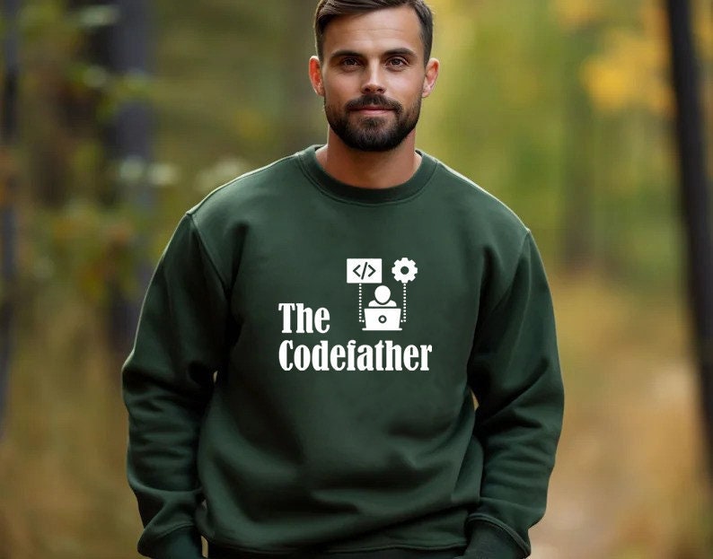 May include: A dark green sweatshirt with a white graphic design that says "The Codefather" and features a computer, a person, and code symbols.