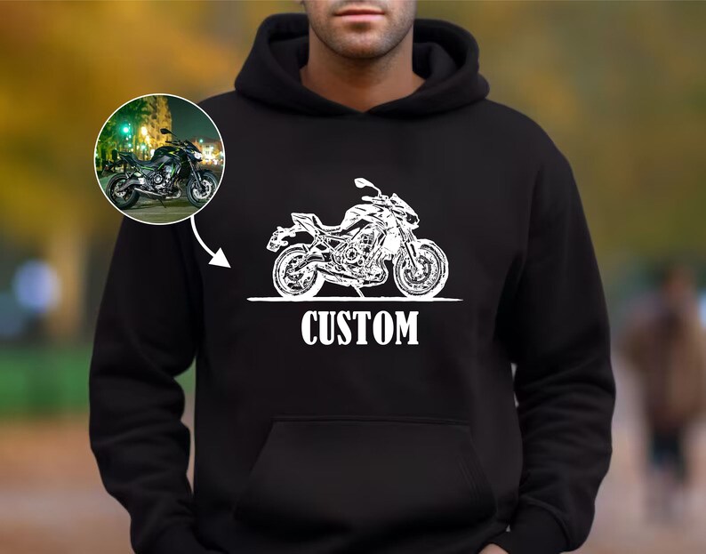 May include: Black hooded sweatshirt with a white silhouette of a motorcycle and the word "CUSTOM" printed on the front.