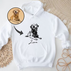 May include: White hoodie with a black and white illustration of a dog with the name "Luna" printed below it.