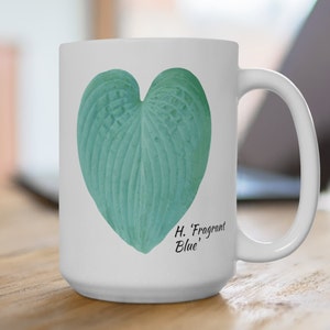 May include: White ceramic mug with a heart-shaped green leaf design and the text "H. 'Fragrant Blue'" printed on the bottom.