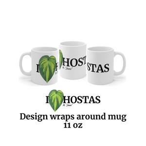 May include: White ceramic mug with a green and yellow hosta leaf design and the text "I Hostas H. June" wrapped around the mug. The mug is 11 oz.