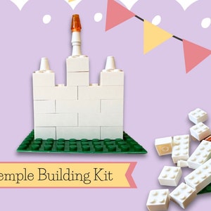 May include: A white temple building kit made of interlocking blocks. The temple is constructed on a green base, with a tall spire topped with an orange piece. The words "Temple Building Kit" are displayed on a banner.