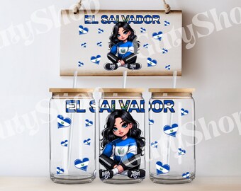 May include: Three clear glass tumblers with lids and straws. Each tumbler has a cartoon girl with long black hair wearing a blue and white shirt with the El Salvador flag on it. The tumblers are decorated with blue and white hearts with the El Salvador flag on them. The text "EL SALVADOR" is printed on the tumblers.