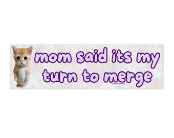 May include: A sticker with a cartoon cat and the text "mom said its my turn to merge".