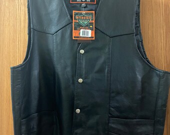 May include: Black leather vest with a snap closure and two pockets. The vest has a label that reads "Interstate Leather" and "Made for the Long Haul".