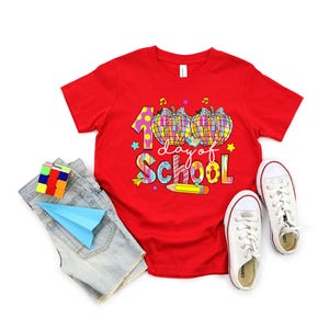 May include: Red t-shirt with a colorful graphic of two pumpkins and the text "100 days of school".