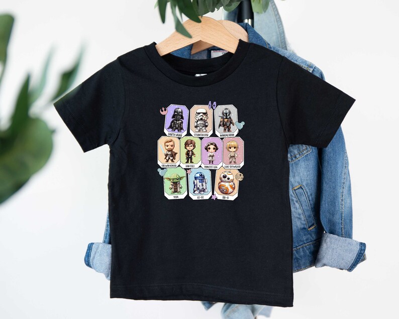 May include: Black short-sleeved t-shirt with a colorful graphic of Star Wars characters. The characters are in a grid pattern with their names below each character.