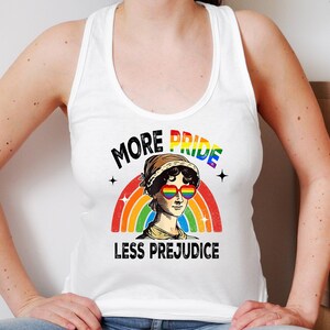 May include: White tank top with a rainbow and the text "More Pride Less Prejudice". A woman with rainbow heart-shaped sunglasses is in the centre of the rainbow.