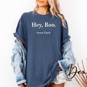 May include: A dark blue t-shirt with the text "Hey, Boo. - Scout Finch" printed in white.