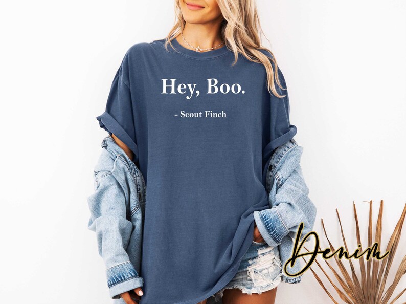 May include: A dark blue t-shirt with the text "Hey, Boo. - Scout Finch" printed in white.