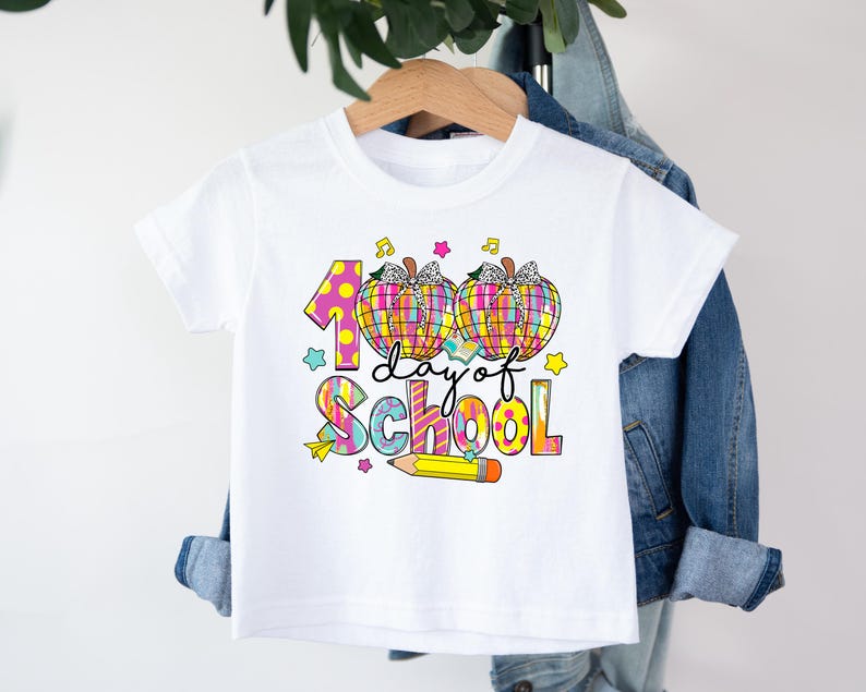 May include: White t-shirt with a colorful graphic that says "100 day of school" with two pumpkins and a pencil.