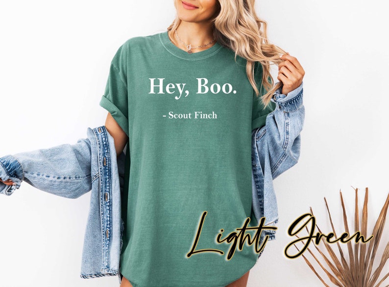 May include: A light green t-shirt with the text "Hey, Boo. - Scout Finch" printed in white.