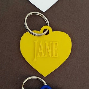 Porte-clés personnalisé coeur étiquette de nom de bouteille d'eau étiquette de nom étiquette de sac petits cadeaux sac à langer à fermeture éclair porte-clés boîte à lunch porte-clés