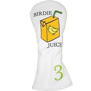 May include: White golf headcover with a yellow juice box design. The juice box has a yellow bird and the text "Birdie Juice". The number "3" is embroidered on the bottom of the headcover.