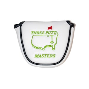 May include: White golf club head cover with black trim. It features an embroidered green outline of the United States with a red flag and the text "THREE PUTT MASTERS".