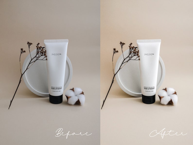 May include: A white tube of 2ND SKIN  'Derma Peel Gel Tone Up Boost' face cream on a white round platform with a small cotton flower next to it. The background is a light beige color.