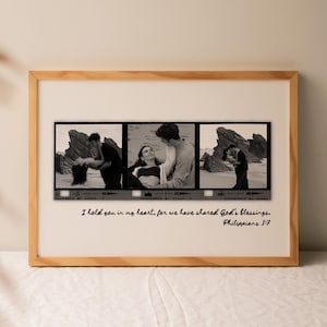 May include: A framed print featuring three black and white photographs of a couple. The photographs are arranged in a horizontal strip, resembling film negatives. The frame is made of light-colored wood. The text "I hold you in my heart, for we have shared God's blessings. Philippians 1:7" is written below the photographs.
