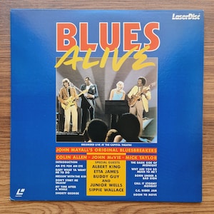 May include: A blue and yellow laserdisc cover for the album "Blues Alive" by John Mayall's Original Bluesbreakers. The cover features a photo of the band performing on stage. The album features special guests Albert King, Etta James, Buddy Guy, Junior Wells, and Sippie Wallace.