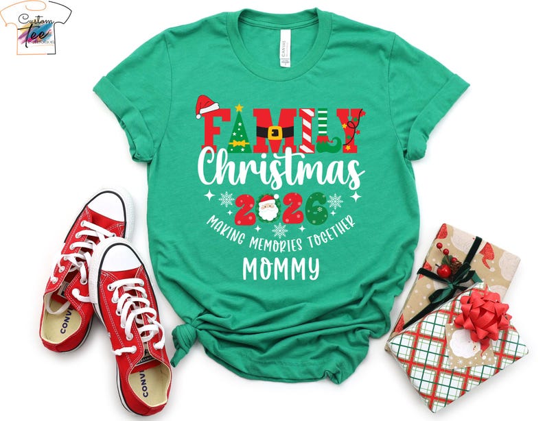May include: A green t-shirt with the words "FAMILY Christmas 2026" in a festive design, along with the phrase "MAKING MEMORIES TOGETHER MOMMY." Red trainers and wrapped gifts with bows are also in the image.