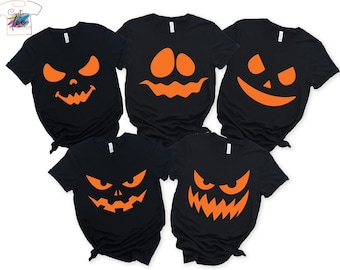 May include: Five black t-shirts with orange jack-o'-lantern faces. Each shirt features a different design, including various eye and mouth shapes. The shirts are short-sleeved and suitable for Halloween.