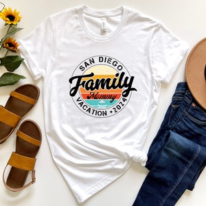 May include: White t-shirt with a black circle graphic that says "San Diego Family Mommy Vacation 2026" with a retro sunset design.