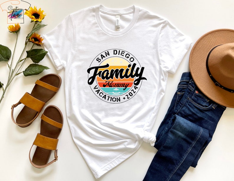 May include: White t-shirt with a black circle graphic that says "San Diego Family Mommy Vacation 2026" with a retro sunset design.