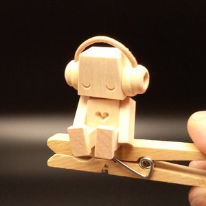 Tiny Robot clothespin automaton listening to headphones (it bobs its head to the music when you squeeze the clothespin!)