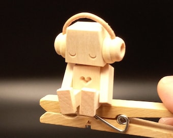 Tiny Robot Automaton listening to headphones (it bobs it's head to the music when you squeeze the clothespin!)