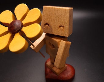 Niño Flor (Un pequeño robot que sostiene una flor)