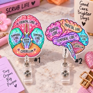May include: Two glittery badge reels featuring anatomical brain illustrations. The left reel shows a frontal view labelled Frontal Lobe, Temporal Lobe, Brain Stem, and Cerebellum. The right reel shows a side view labelled Frontal Lobe, Parietal Lobe, Temporal Lobe, Occipital Lobe, Brain Stem, and Cerebellum.