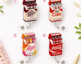 Könnte beinhalten: Vier Ausweishalter aus Acryl mit einem Zigarettenschachtel-Design, beschriftet mit FRIDGE CIGS. Jede Packung zeigt Getränkedosen und den Text JUST A LITTLE SOMETHING TO TAKE THE EDGE OFF. Die Designs umfassen Dr Pepper, Diet Coke, Alani und Coca-Cola.