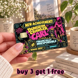 May include: A rectangular credit card skin featuring a black background with vibrant pink and yellow graphics. The text reads NEW ACHIEVEMENT! DUNGEON CRAWLER CARL, FINANCIALLY IRRESPONSIBLE, and REWARD: DEBT, alongside illustrations of a cat and a warrior.
