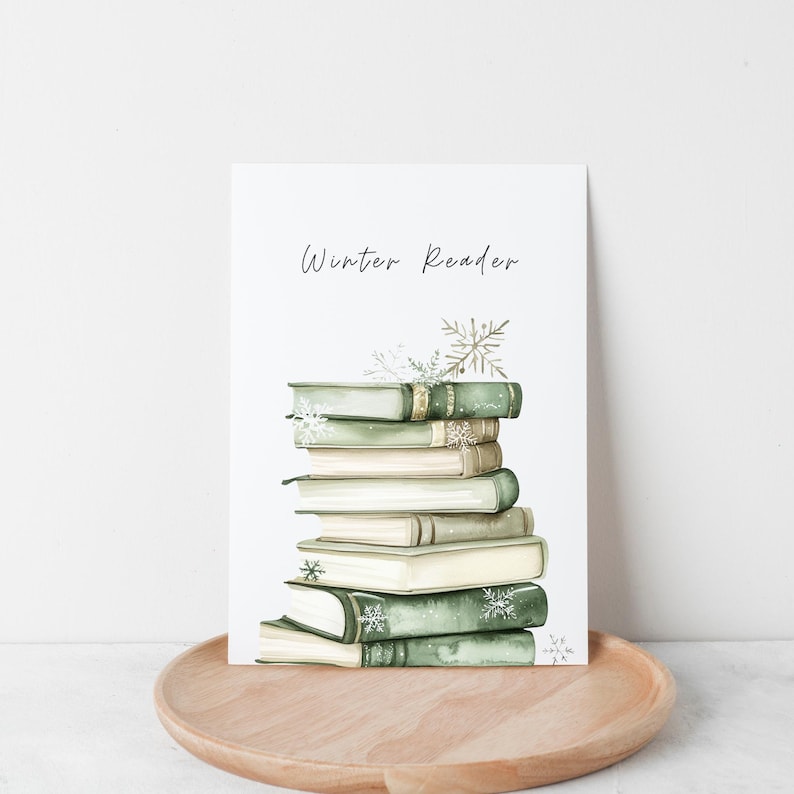 May include: A stack of books with green and brown covers, decorated with snowflakes, on a white background. The text "Winter Reader" is written above the books.